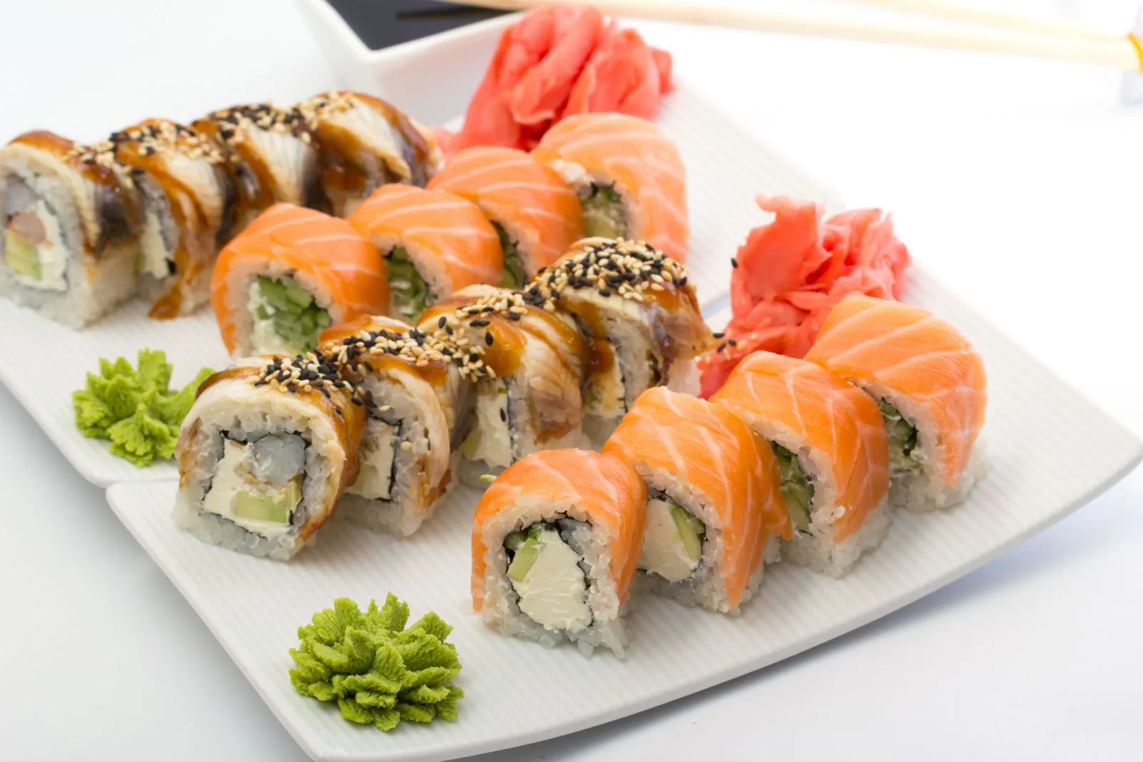 Sesame‑crusted shrimp avocado maki rolls served with pickled ginger and soy sauce